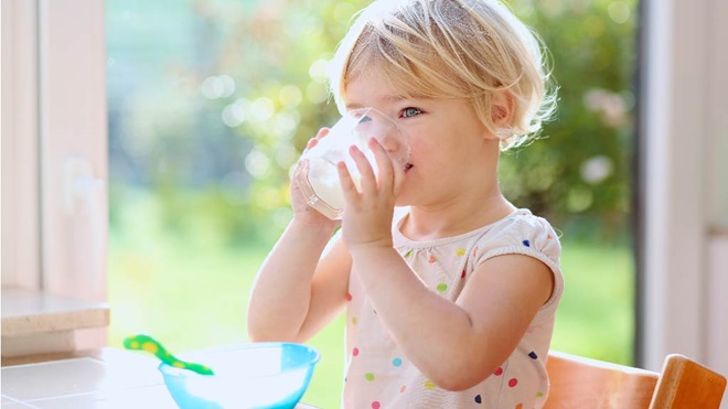 young girl drinking milk